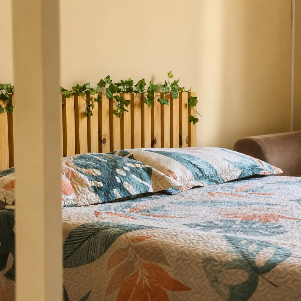 Double bed with a wooden headboard and climbing plant